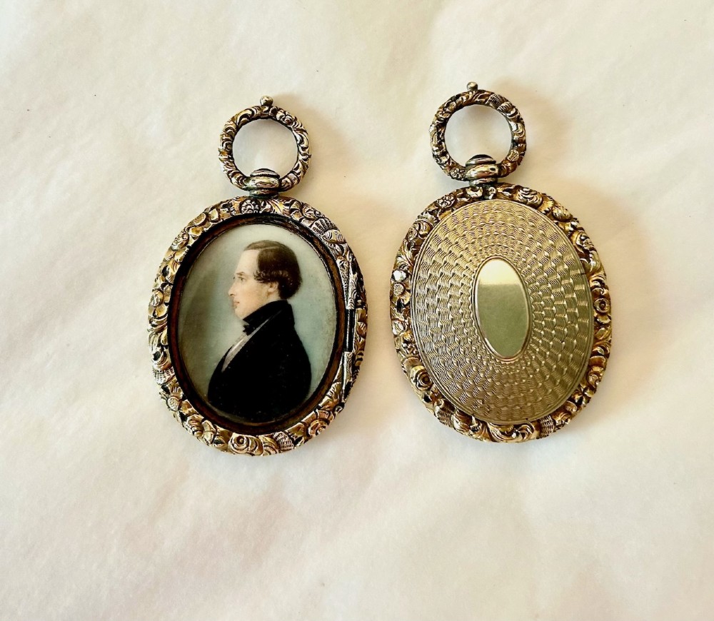 A Pair of Late 18th Century Portrait Miniatures of a Husband and Wife in Gilt Oval Frames View III