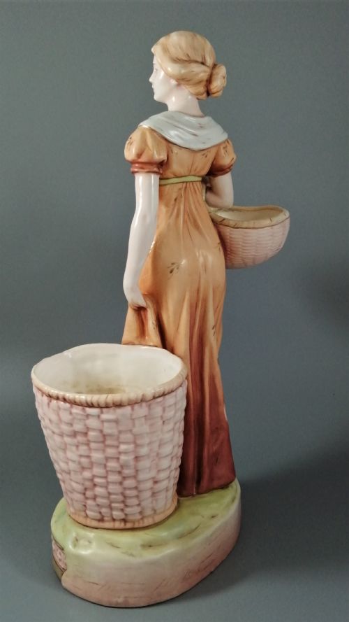fig 3. Antique Royal Dux figurine of a woman with wicker baskets