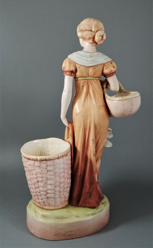 fig 4. Antique Royal Dux figurine of a woman with wicker baskets