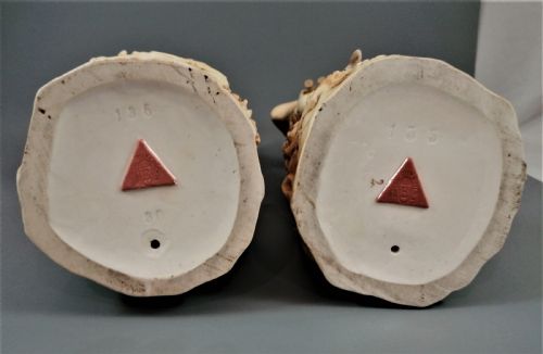 fig 5. A pair of antique Royal Dux porcelain statuettes depicting a shepherdess holding a staff beside goats and a shepherd playing a pipe beside sheep.