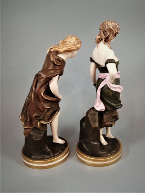 fig 3. A pair of nineteenth-century Royal Worcester porcelain figurines depicting draped female figures with windblown hair and garments.