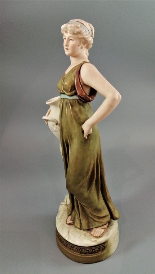 fig 1. Beautiful antique Royal Dux porcelain figurine depicting a lady holding a jug.