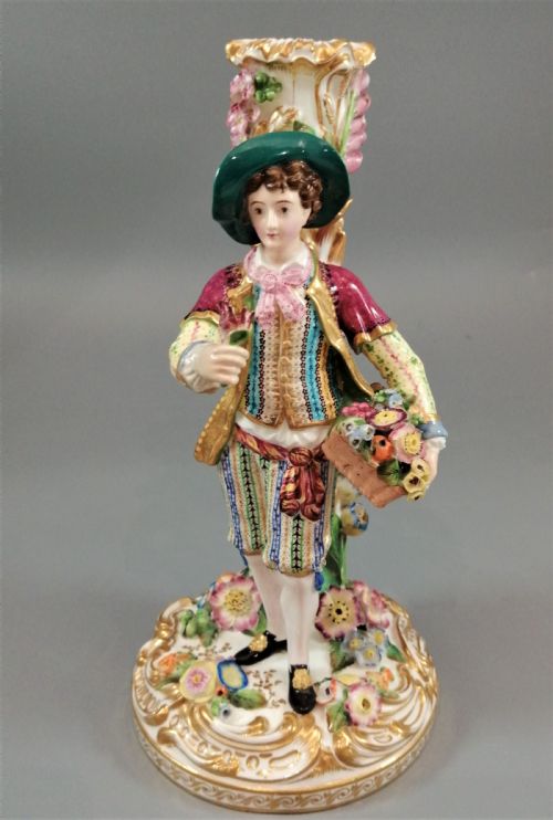 fig 4. A pair of hand-painted Minton porcelain figural candlesticks featuring a male and female figure in colourful traditional dress with floral motifs and gilded scroll bases.