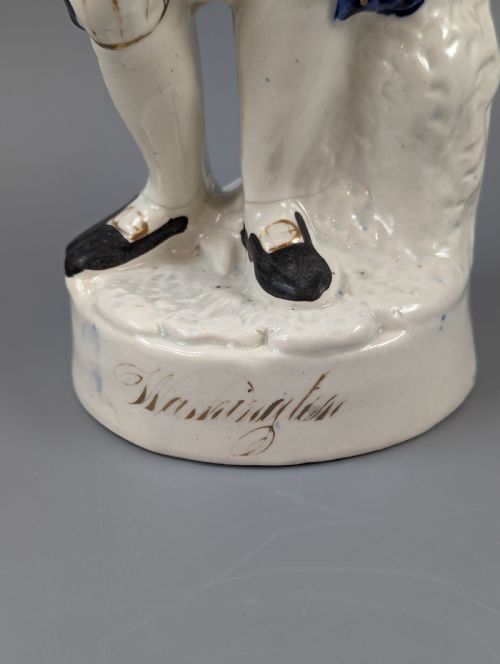fig 1. A Victorian Staffordshire earthenware figure of Benjamin Franklin standing in a cobalt blue coat and holding a tricorn hat, set on a pedestal inscribed Washington.