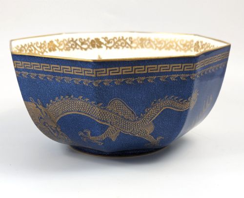 fig 1. An octagonal cobalt blue ceramic bowl featuring gilded celestial dragon motifs and a Greek key upper rim.