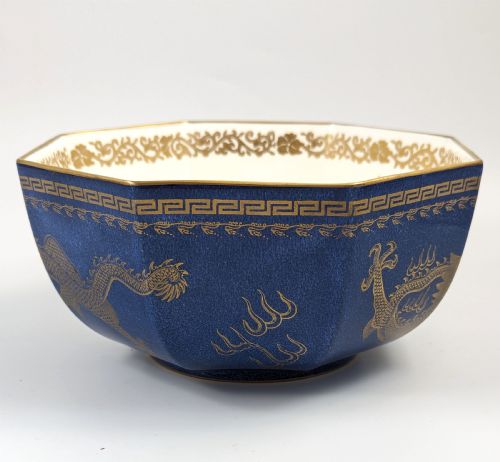 fig 2. An octagonal cobalt blue ceramic bowl featuring gilded celestial dragon motifs and a Greek key upper rim.