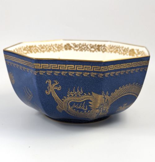 fig 3. An octagonal cobalt blue ceramic bowl featuring gilded celestial dragon motifs and a Greek key upper rim.