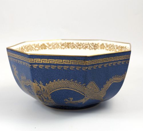 fig 4. An octagonal cobalt blue ceramic bowl featuring gilded celestial dragon motifs and a Greek key upper rim.