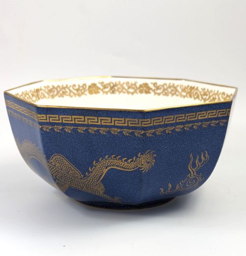 fig 5. An octagonal cobalt blue ceramic bowl featuring gilded celestial dragon motifs and a Greek key upper rim.