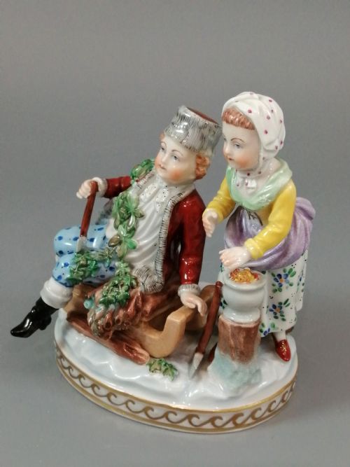fig 1. A Carl Thieme Potschappel hand-painted porcelain figurine depicting a young couple in eighteenth-century winter costume beside a sledge and brazier.