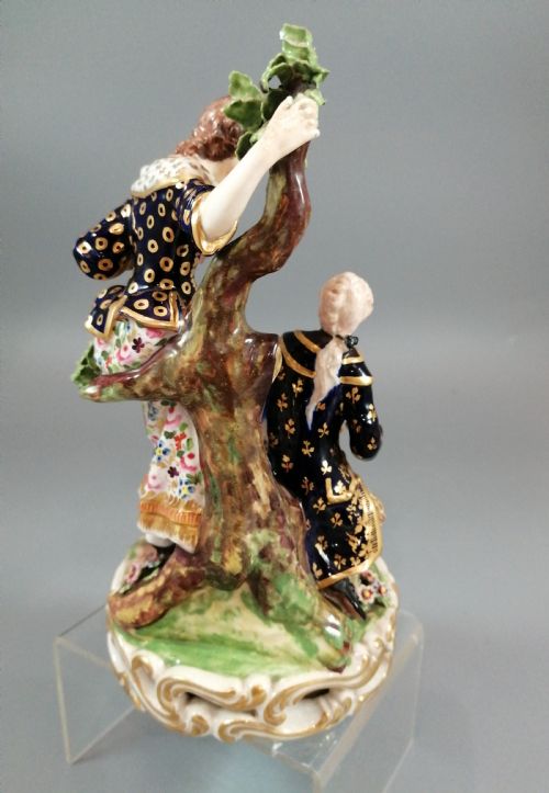 fig 3. Early 19th-century Derby porcelain figural group depicting a shoemaker and a standing lady beside a tree on a gilded scroll base.