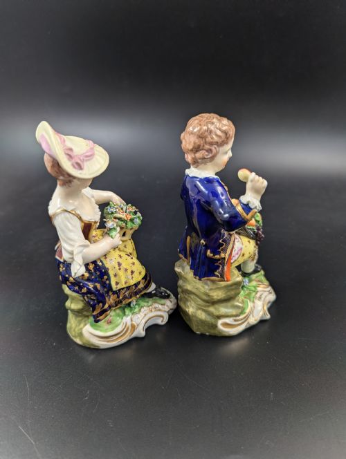 fig 3. A pair of antique hand-painted Derby porcelain figurines featuring a young female gardener with a basket of flowers and a male gardener holding fruit on gilt scroll bases.