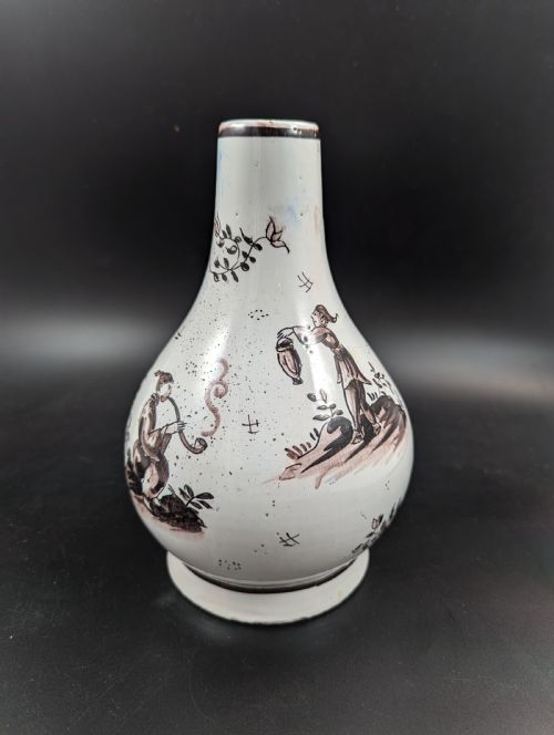 fig 1. A mid-18th-century tin-glazed earthenware vase with a pear-shaped body, decorated with hand-painted manganese Chinoiserie figures.