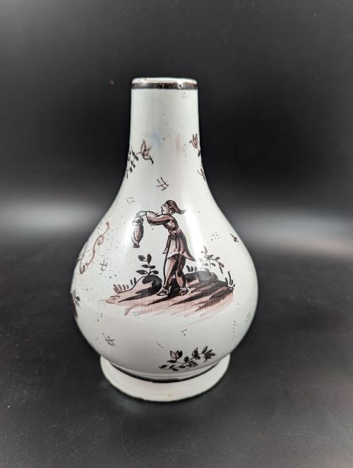 fig 2. A mid-18th-century tin-glazed earthenware vase with a pear-shaped body, decorated with hand-painted manganese Chinoiserie figures.