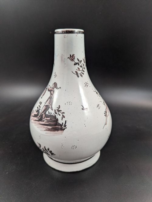 fig 3. A mid-18th-century tin-glazed earthenware vase with a pear-shaped body, decorated with hand-painted manganese Chinoiserie figures.