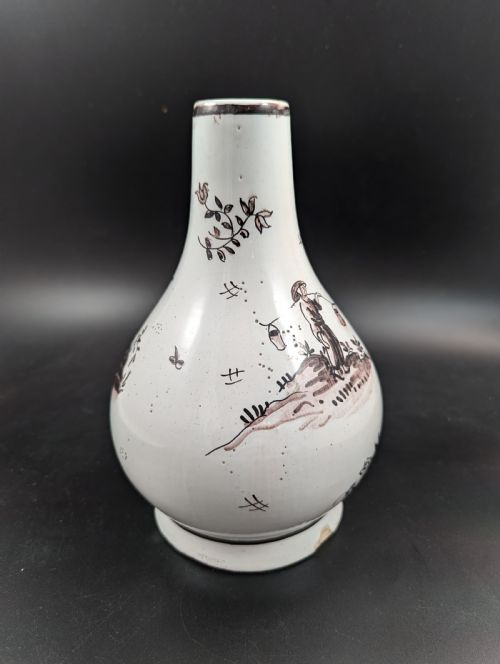 fig 4. A mid-18th-century tin-glazed earthenware vase with a pear-shaped body, decorated with hand-painted manganese Chinoiserie figures.