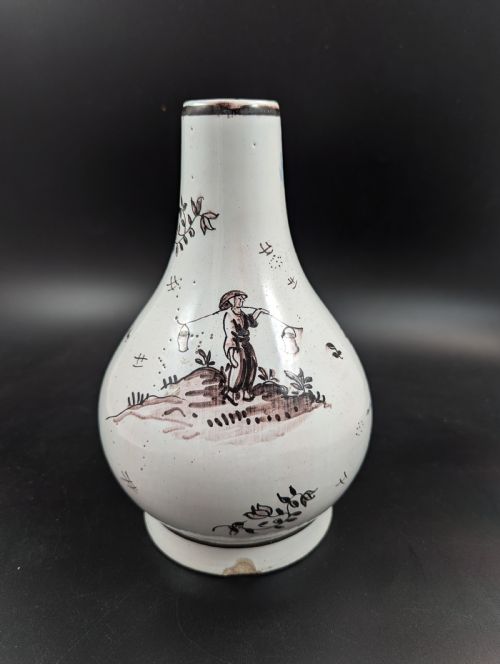 fig 5. A mid-18th-century tin-glazed earthenware vase with a pear-shaped body, decorated with hand-painted manganese Chinoiserie figures.