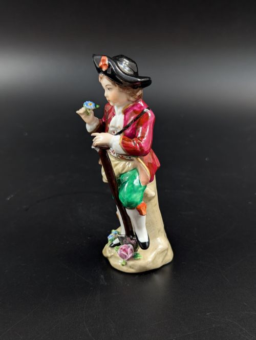 fig 1. Lovely early 20th century Sitzendorf porcelain figurine of a young gardener.