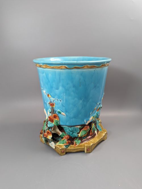 fig 1. A Victorian Royal Worcester turquoise majolica jardiniere planter featuring relief-moulded foliage and a faux-woodland base.
