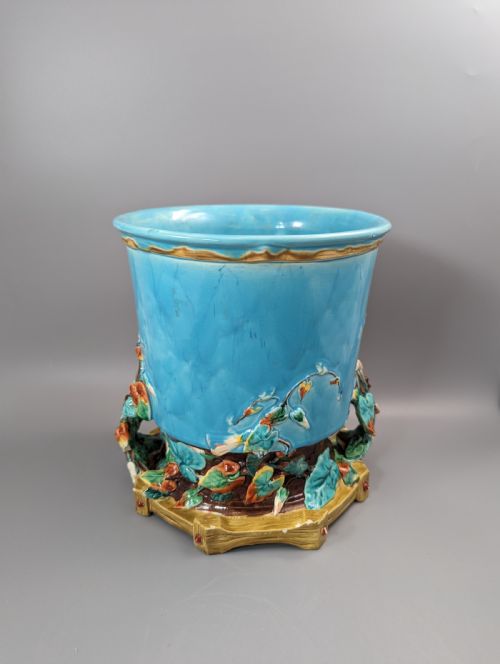 fig 2. A Victorian Royal Worcester turquoise majolica jardiniere planter featuring relief-moulded foliage and a faux-woodland base.