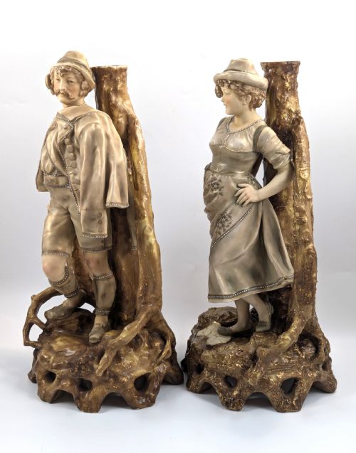 fig 1. A pair of nineteenth-century Bohemian porcelain figurines depicting a man and woman in folk attire framed by gilded root-like arbours on sculpted bases.