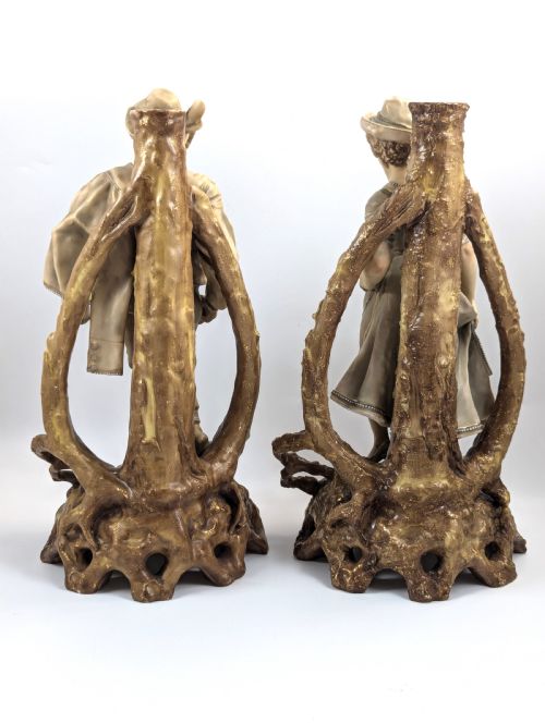 fig 2. A pair of nineteenth-century Bohemian porcelain figurines depicting a man and woman in folk attire framed by gilded root-like arbours on sculpted bases.