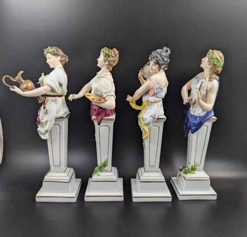 fig 1. A set of four 19th-century glazed Italian porcelain figurines depicting allegorical female figures representing the arts atop gilded square pedestals.