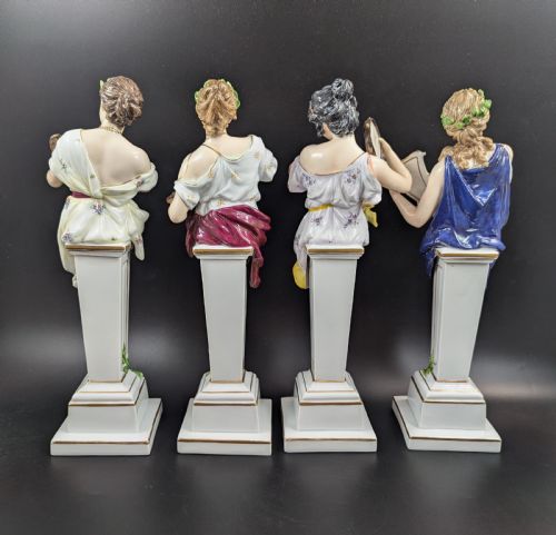 fig 2. A set of four 19th-century glazed Italian porcelain figurines depicting allegorical female figures representing the arts atop gilded square pedestals.