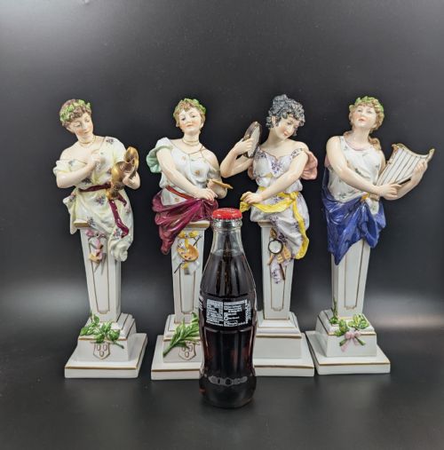 fig 3. A set of four 19th-century glazed Italian porcelain figurines depicting allegorical female figures representing the arts atop gilded square pedestals.
