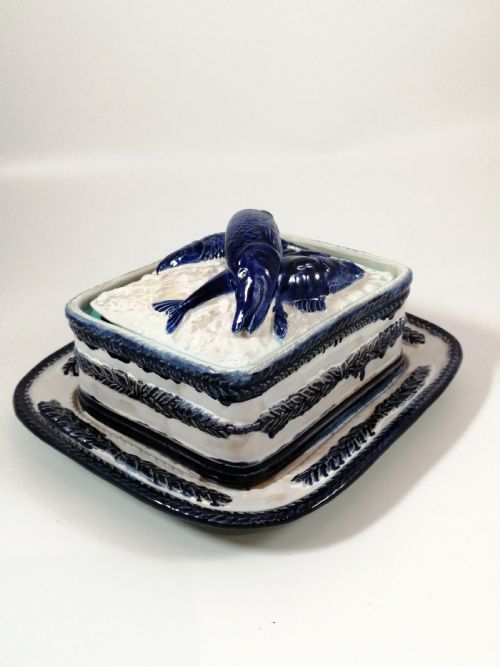 fig 1. A rectangular Victorian majolica sardine box with matching undertray featuring cobalt blue fish relief decoration on an off-white lid.