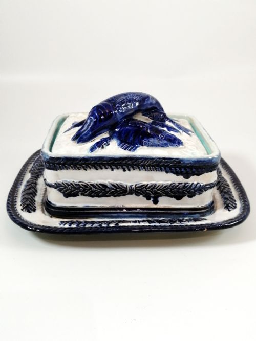 fig 2. A rectangular Victorian majolica sardine box with matching undertray featuring cobalt blue fish relief decoration on an off-white lid.