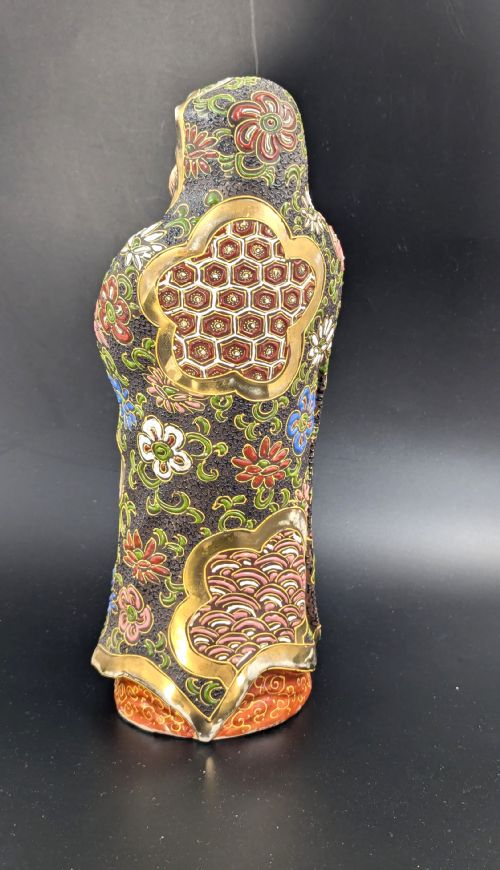 fig 3. A Japanese Satsuma earthenware figurine depicting a bearded Daruma monk wearing a hooded robe with polychrome enamels and gold accents.