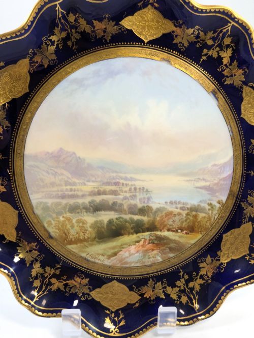 fig 2. A Victorian Aynsley porcelain cabinet plate featuring a central hand-painted landscape surrounded by a scalloped cobalt blue border with intricate gold leaf ornamentation.