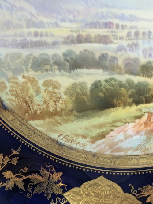 fig 3. A Victorian Aynsley porcelain cabinet plate featuring a central hand-painted landscape surrounded by a scalloped cobalt blue border with intricate gold leaf ornamentation.
