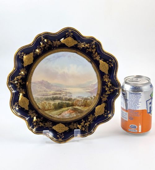 fig 4. A Victorian Aynsley porcelain cabinet plate featuring a central hand-painted landscape surrounded by a scalloped cobalt blue border with intricate gold leaf ornamentation.