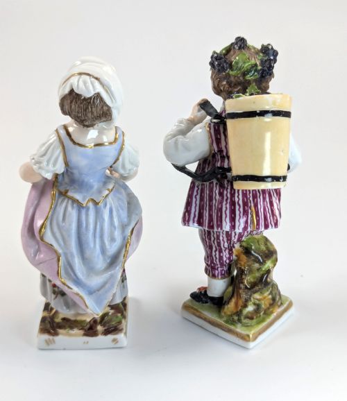 fig 2. Pair of late 19th-century Helena Wolfsohn porcelain child figurines featuring hand-painted floral attire, baskets, and gilded bases.