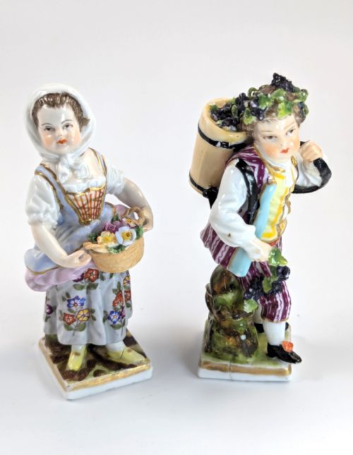 fig 4. Pair of late 19th-century Helena Wolfsohn porcelain child figurines featuring hand-painted floral attire, baskets, and gilded bases.
