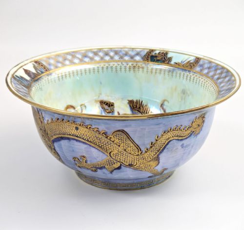 fig 4. An antique light blue lustre porcelain bowl decorated with a detailed gilded dragon motif around the exterior.