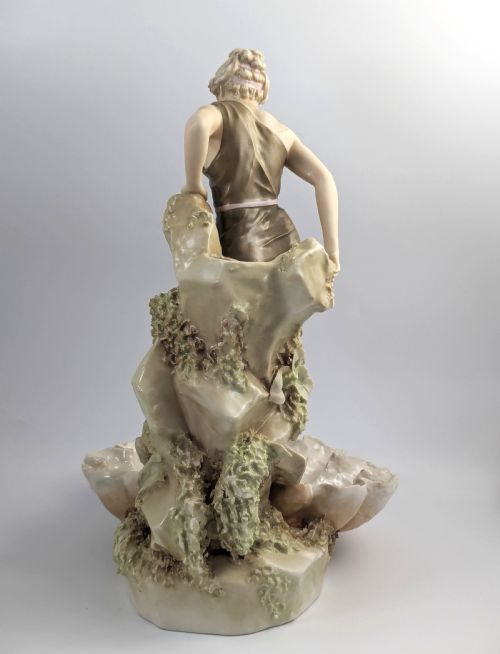 fig 3. An Art Nouveau Royal Dux porcelain centrepiece depicting a draped female bather standing atop rockwork above a large shell-shaped basin.