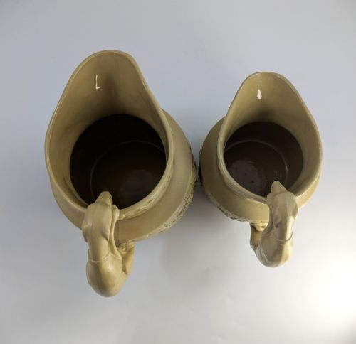 fig 6. A graduated set of three buff yellow Regency ceramic pitchers featuring relief-moulded stag hunting scenes and sculpted hound handles.