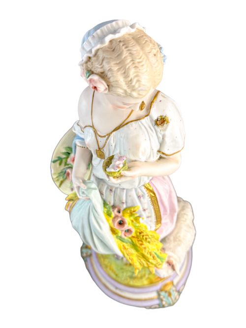 fig 6. A pair of large French bisque porcelain sculptures featuring a shepherd and shepherdess with animals on gilded bases.