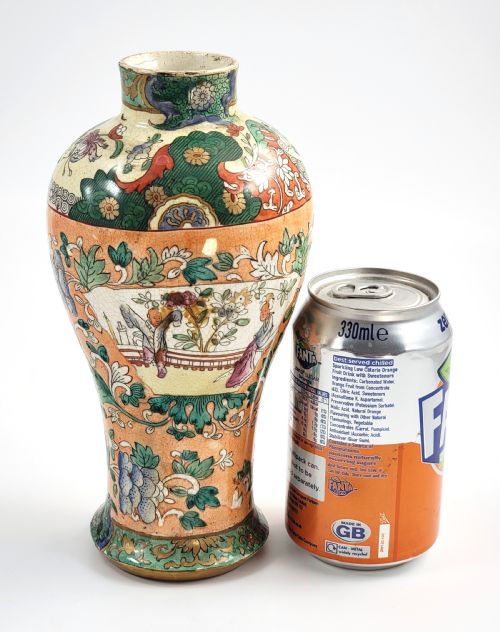 fig 3. A Regency period baluster-shaped Miles Mason ironstone vase featuring an orange background with intricate hand-painted Chinoiserie floral patterns and polychrome enamel detailing.
