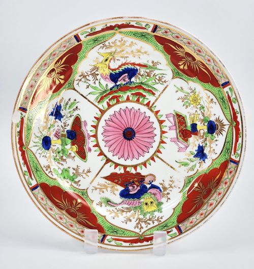 fig 1. A circular antique English porcelain dessert plate decorated with hand-painted Chinoiserie panels, mythical dragons, and a pink central flower motif.