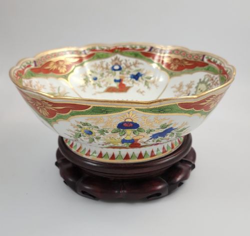 fig 2. A Regency Chamberlain Worcester porcelain bowl with scalloped edges and colourful Chinoiserie enamel painting, resting on a carved dark mahogany stand.