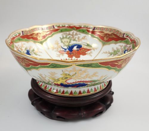 fig 3. A Regency Chamberlain Worcester porcelain bowl with scalloped edges and colourful Chinoiserie enamel painting, resting on a carved dark mahogany stand.