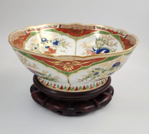 fig 4. A Regency Chamberlain Worcester porcelain bowl with scalloped edges and colourful Chinoiserie enamel painting, resting on a carved dark mahogany stand.