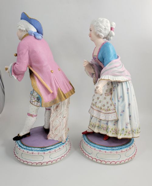 fig 2. A pair of late 19th-century French biscuit porcelain figures depicting an 18th-century courtly man and woman with pastel pink and blue painted garments.