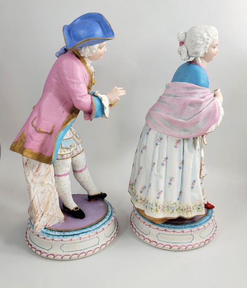fig 3. A pair of late 19th-century French biscuit porcelain figures depicting an 18th-century courtly man and woman with pastel pink and blue painted garments.