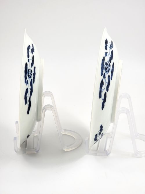fig 1. A near-pair of circular white Japanese porcelain plates decorated with hand-painted cobalt blue depictions of two koi fish.