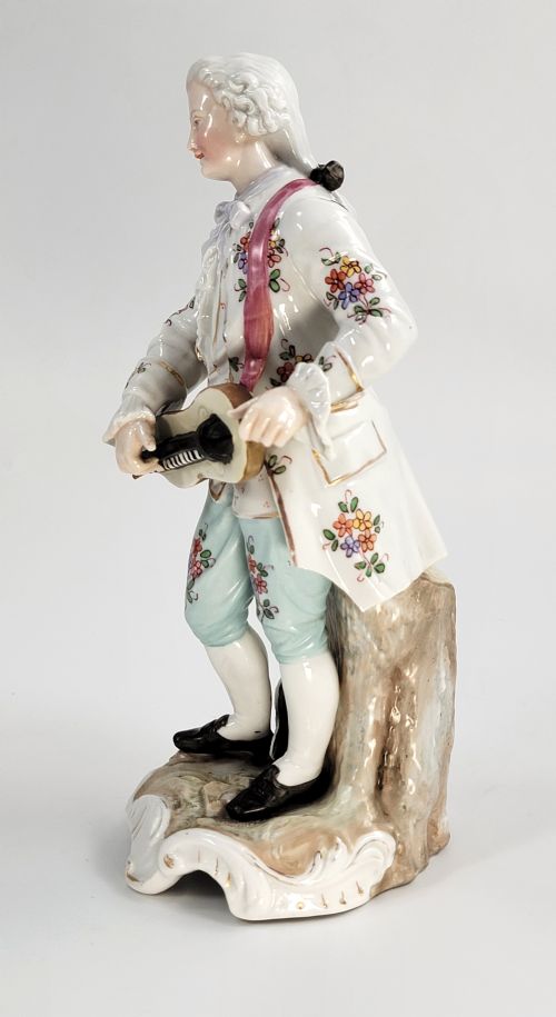 fig 1. A Samson of Paris porcelain figure depicting an eighteenth-century male musician holding a hurdy-gurdy, decorated with hand-painted floral motifs and gilding.